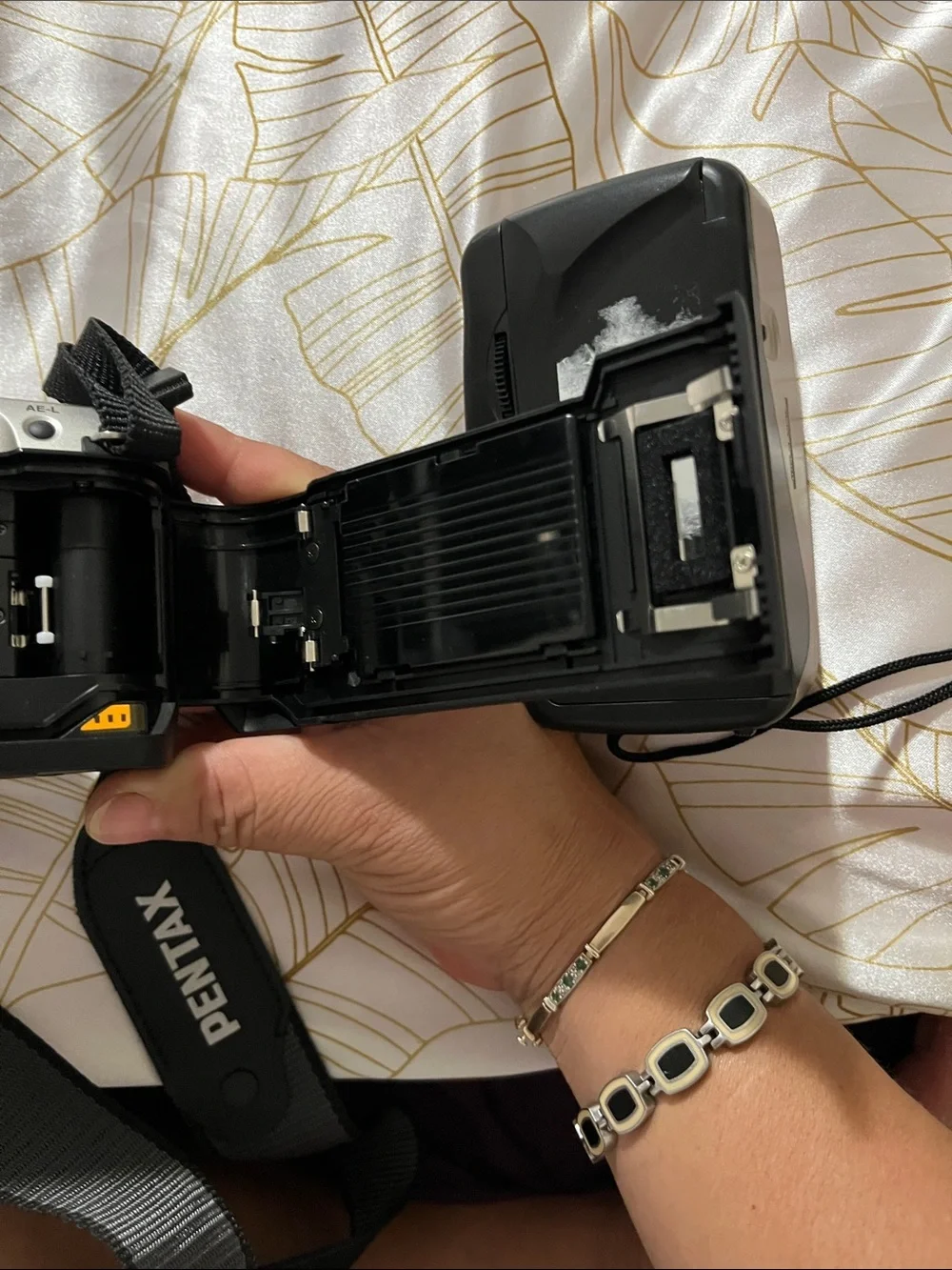 Pentax Silver and Black DSLR with 28-90mm Zoom Lens and Branded Strap